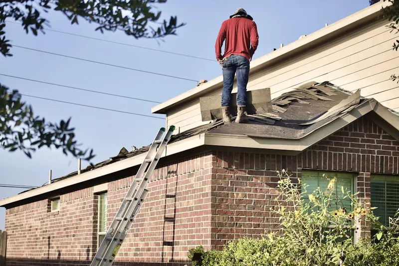 Professional roofer working on a residential roof in Halcon